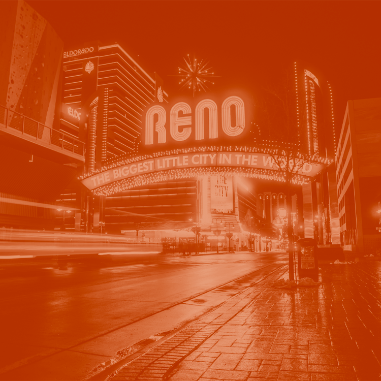 The Reno Nevda arch lit up at night. The image is edited with an orange duotone look.