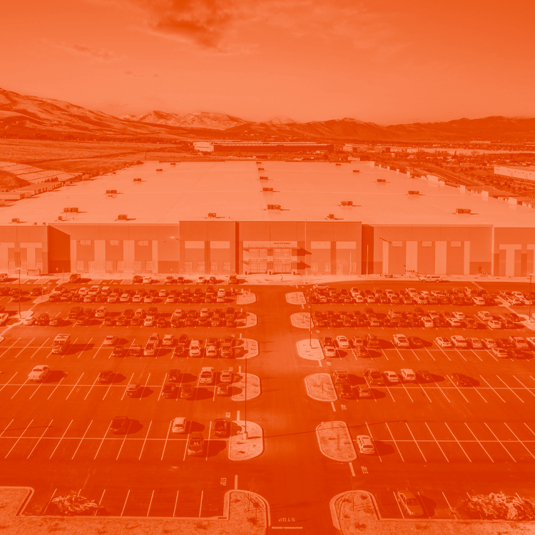 Aerial view of the Reno Logistic Center that is currently fully leased by the Chewy company. The image is edited with an orange duotone look.