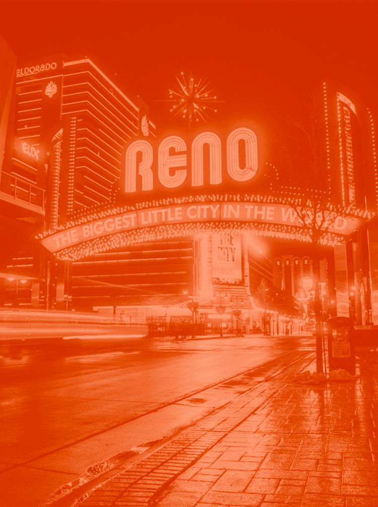 The Reno Nevda arch lit up at night. The image is edited with an orange duotone look.